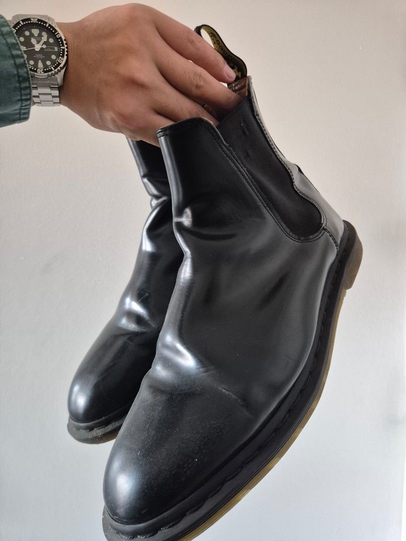 Dr. Martens Black Chelsea Boots (Category: Boots) located in Makati City. Submitted by tapsj (Listing ID 1469702321, Image 3). Description: - Brand: Dr. Martens - Style: Black leather Chelsea boots - Fit: Elastic side panels for easy slip-on - Details: Classic pull loops with iconic yellow stitching - Soles: Signature bouncing rubber soles with solid tread - Condition: Normal leather creasing from wear; soles have minor dirt.