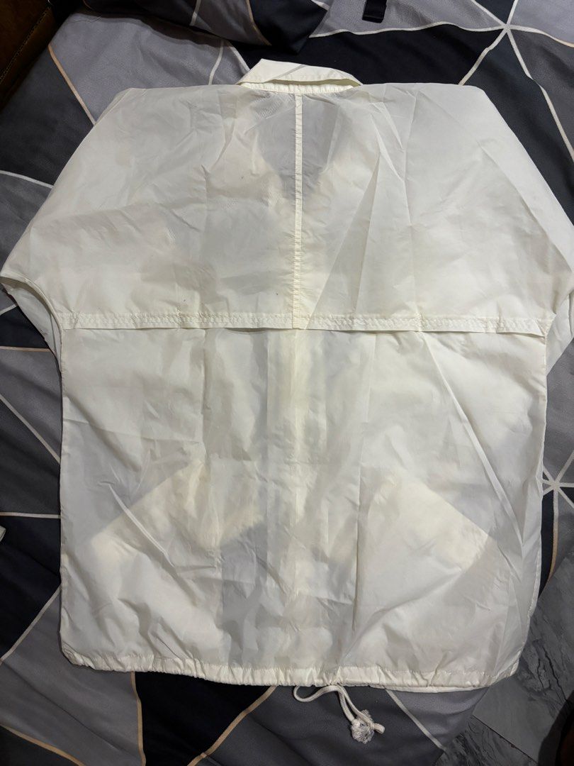 Dunlop Windbreaker Jacket (Category: Coats, Jackets and Outerwear) located in Manila. Submitted by bizcuits (Listing ID 1469739511, Image 2). Description: - Brand: Dunlop - Color: Off White - Size: Large (L) 23 width by 30 length - Design: Full front zip with fold-down collar and small gold embroidered chest logo - Features: Front pockets, drawstring hem, and breathable mesh lining - Condition: Great lightweight outer layer, ideal for breezy days