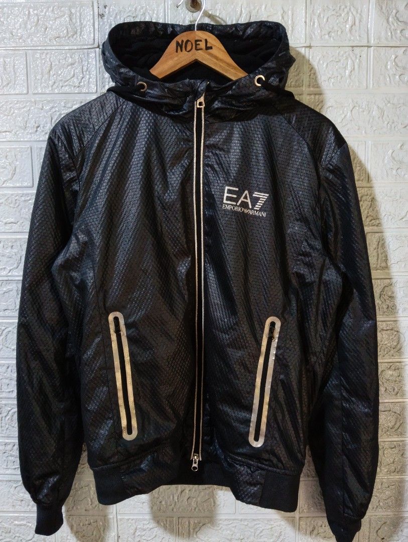 EA7 Emporio Armani Black Hooded Jacket (Category: Coats, Jackets and Outerwear) located in Davao. Submitted by noelamihan05424 (Listing ID 1469621995, Image 2). Description: - Brand: EA7 Emporio Armani - Color: Black with stylish textured pattern throughout - Closure: Full zip with sleek silver accents - Pockets: Convenient zippered side pockets - Safety/Style: Reflective strip detail on the back - Fit: Ribbed cuffs and hem to block out the wind 