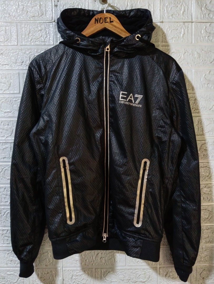 EA7 Emporio Armani Black Hooded Jacket (Category: Coats, Jackets and Outerwear) located in Davao. Submitted by noelamihan05424 (Listing ID 1469621995, Image 1). Description: - Brand: EA7 Emporio Armani - Color: Black with stylish textured pattern throughout - Closure: Full zip with sleek silver accents - Pockets: Convenient zippered side pockets - Safety/Style: Reflective strip detail on the back - Fit: Ribbed cuffs and hem to block out the wind 