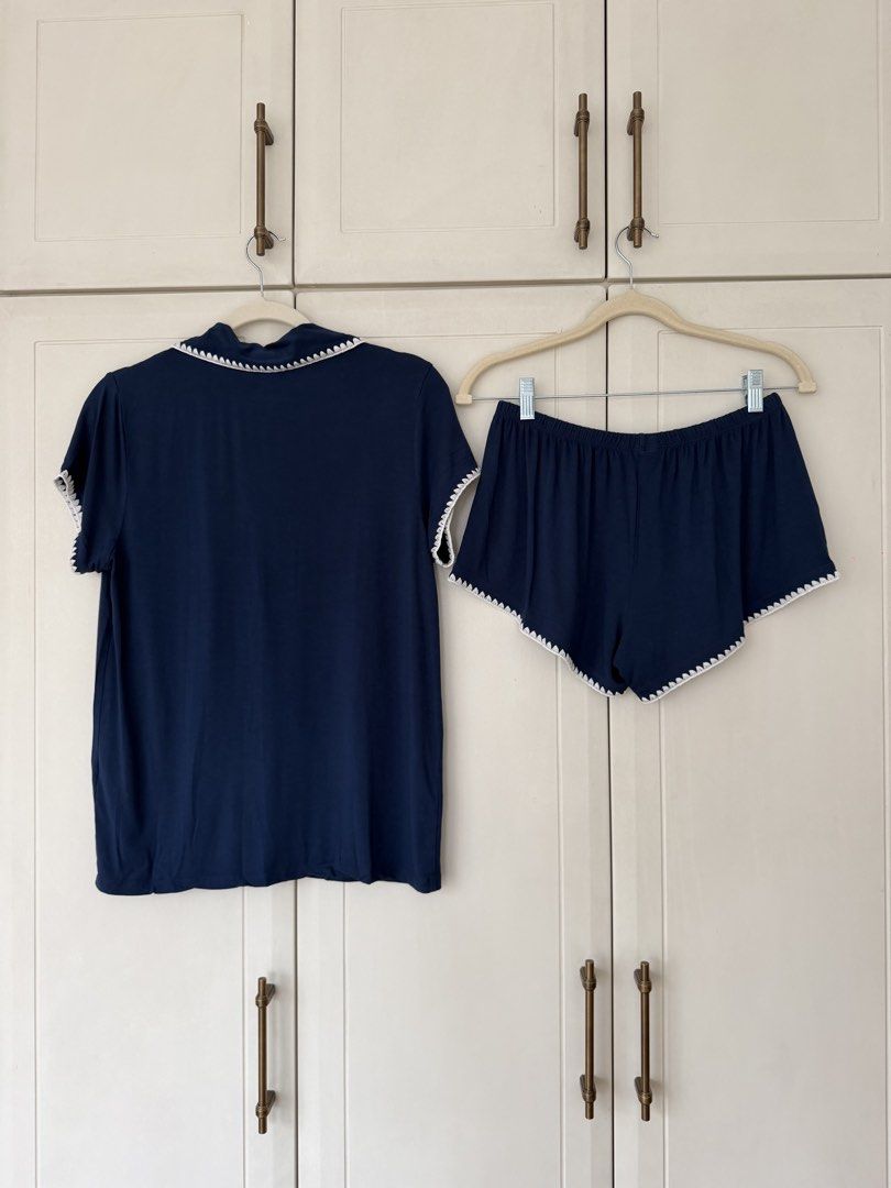 Eberjey Navy Blue Short Sleeve Pajama Set (Category: Sets or Coordinates) located in Makati City. Submitted by belizalde4 (Listing ID 1469657942, Image 3). Description: - Color: Navy blue with white scalloped stitching - Set includes: Short sleeve button-up top with chest pocket and matching shorts - Material: Super soft and comfortable fabric - Ideal for: Sleeping or lounging at home.