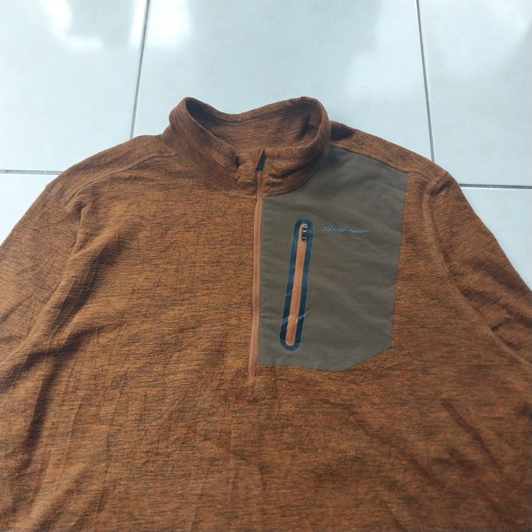 Eddie Bauer Brown Fleece 1/2 Zip Pullover (Category: Coats, Jackets and Outerwear) located in Cavite. Submitted by spinfits (Listing ID 1469710705, Image 3). Description: - Brand: Eddie Bauer - Style: 1/2 zip fleece pullover - Size: Men's XXL - Color: Warm brown heather with contrast olive green zippered chest pocket - Material: Soft polyester shell with durable nylon-spandex pocket - Care: Machine washable (warm), tumble dry low - Condition: Gre