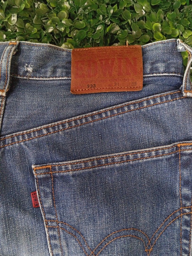 Edwin 503 Denim Jorts Cutoff Shorts (Category: Shorts) located in Sariaya. Submitted by angelochintes732 (Listing ID 1469593399, Image 3). Description: - Brand/Model: Edwin 503 Denim Shorts - Wash/Style: Classic blue wash, cutoff style with raw frayed hems - Details: Iconic leather waist patch, contrast orange stitching - Size: Tagged size 31 x 33 - Measurements: Roughly 16 inches across waist, 24 inches total length - Condition: Great everyday c
