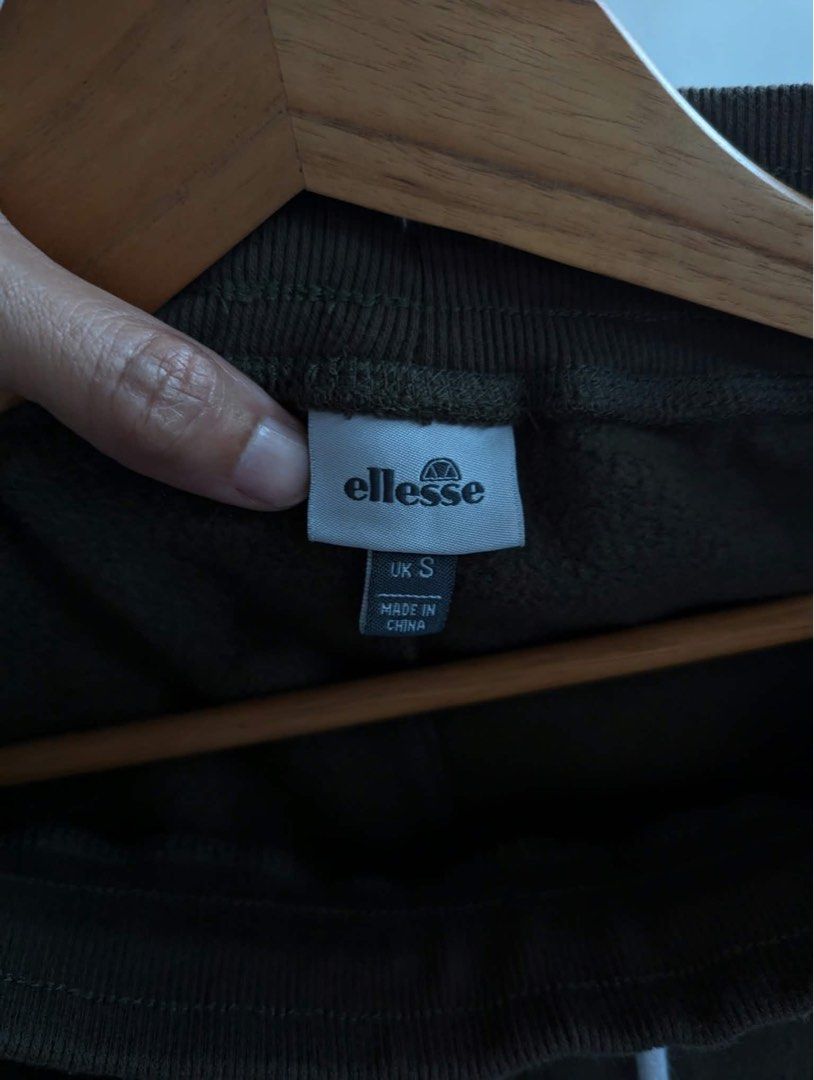 Ellesse Olive Green Sweatpants UK S (Category: Joggers) located in Quezon City. Submitted by thegoodkarmaph (Listing ID 1469681342, Image 3). Description: - Brand: Ellesse - Size: UK Small - Color: Dark olive green - Material: Soft fleece interior lining (Made in China) - Waistband: Thick ribbed with long white drawstrings and silver metal tips - Details: Small white brand logo on left thigh - Cuffs: Elasticated at the ankles.