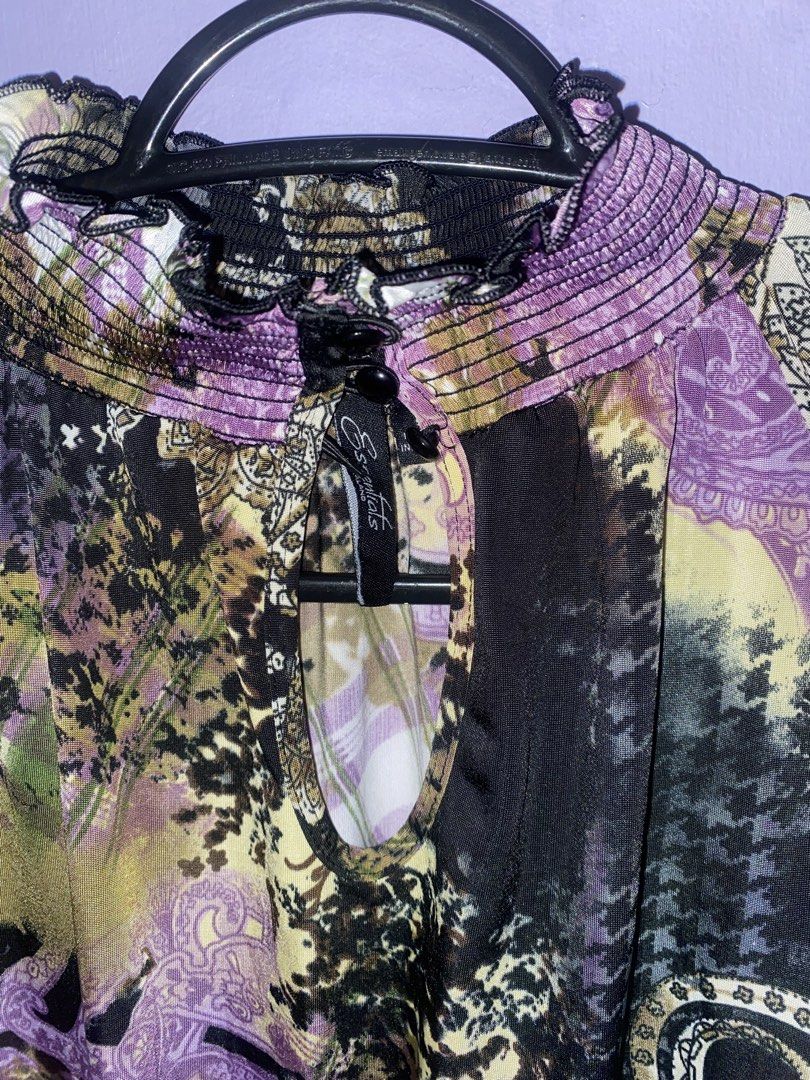 Essentials by Milano multicolor patterned sleeveless blouse size S (Category: Sleeveless) located in Agdangan. Submitted by ishameicnd (Listing ID 1469642704, Image 2). Description: - Brand: Essentials by Milano - Size: Small (Made in Indonesia) - Design: Bold mix of paisley, plaid, and abstract prints in purple, yellow, black, and white - Neckline: High smocked ruffled neck with back button keyhole closure - Style: Sleeveless with a flattering g