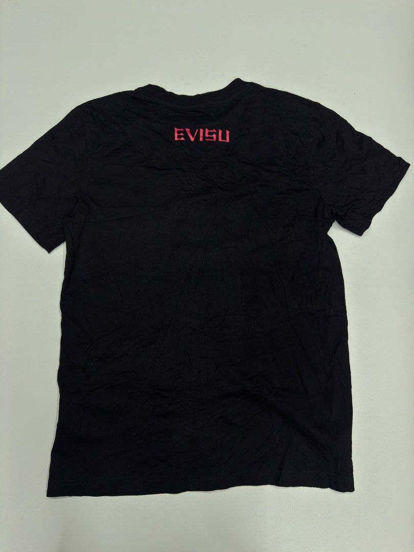 Evisu Heritage Black T-shirt Size M (Category: Tshirts & Polo Shirts ) located in Bustos. Submitted by thenlnclot60500 (Listing ID 1469582132, Image 2). Description: - Brand: Evisu Heritage - Color: Black - Size: Men's Medium (M) - Design: Large pink and gold embroidered seagull logo with "Before anyone did anything evisu did everything" slogan - Details: Small circular gold embroidery, woven brand labels at hem and back neckline - Interior: Stri