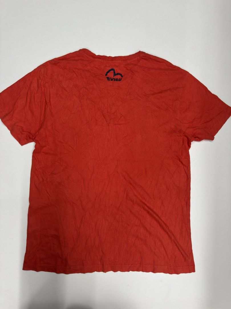Evisu Red T-Shirt with Seagull Logo (Category: Tshirts & Polo Shirts ) located in Bustos. Submitted by thenlnclot60500 (Listing ID 1469589355, Image 2). Description: - Brand: Evisu - Color: Bright red with navy blue seagull logo - Size: 105 - Material: Comfortable premium cotton - Fit: Standard casual fit - Details: Crew neck, short sleeves, subtle branding on chest and upper back neckline.