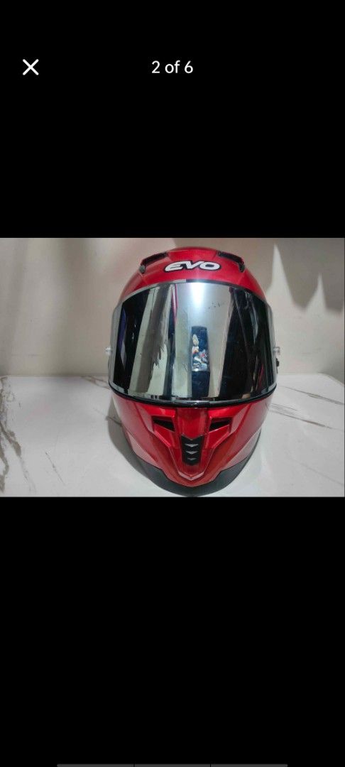 EVO Motorcycle Helmet Red XXL (Category: Helmets and other Riding Gears) located in Manila. Submitted by billythekid05 (Listing ID 1469721170, Image 2). Description: Red EVO motorcycle helmet in size XXL. Glossy finish with large EVO branding on the sides and back. Includes mirrored visor and top ventilation ports. ECE certification sticker on the back. Interior padding intact and clean..