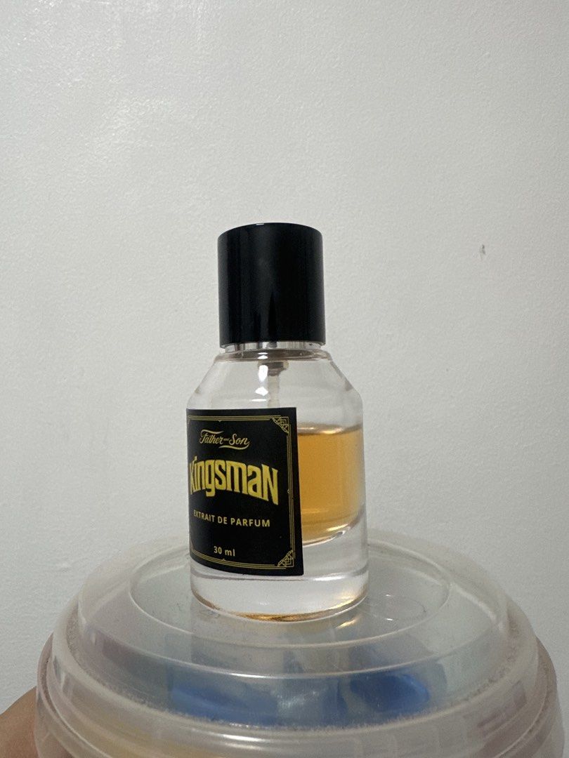 Father and Son Kingsman Extrait de Parfum 30ml (Category: Fragrance & Deodorants) located in Quezon City. Submitted by shopipels (Listing ID 1469642262, Image 2). Description: - Product: Father and Son Kingsman Extrait de Parfum - Volume: barely used, around 80% remaining sprays - Design: Elegant black cap with a sophisticated gold and black label, holding amber-coloured fragrance liquid in a clear glass bottle - Perfect for: Everyday wear or as 