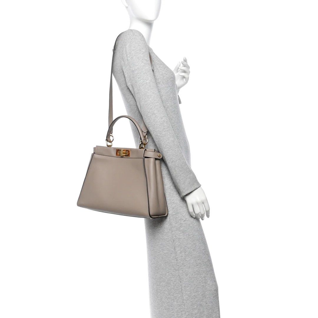 Fendi Peekaboo Handbag Medium (Category: Luxury Bags & Wallets) located in Quezon City. Submitted by aurora.borealis.11 (Listing ID 1430201596, Image 2). Description: Excellent condition, no scuffs! With original dust bag, authenticity card, and long strap. 1st photo is actual bag. 2nd photo from Fashionpile for reference only. Elegant Fendi Peekaboo handbag in a neutral color. Features a top handle and a distinctive turn-lock closure. The hardwa