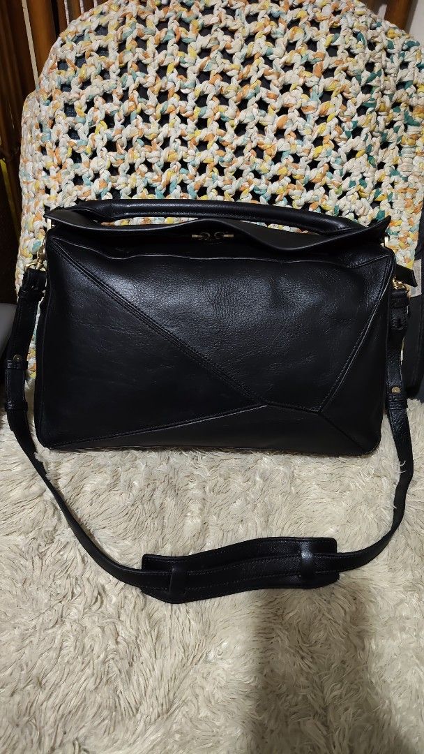 Finn esker (Category: Cross-body Bags) located in Cebu City. Submitted by lumaynojes00490 (Listing ID 1469670311, Image 3). Description: - Material: Premium black leather with soft feel - Design: Iconic geometric paneling with structured shape - Hardware: Gold-tone zippers and clasps - Versatility: Includes a rolled top handle and adjustable shoulder strap - Usage: Perfect daily-sized shoulder bag that matches any outfit.