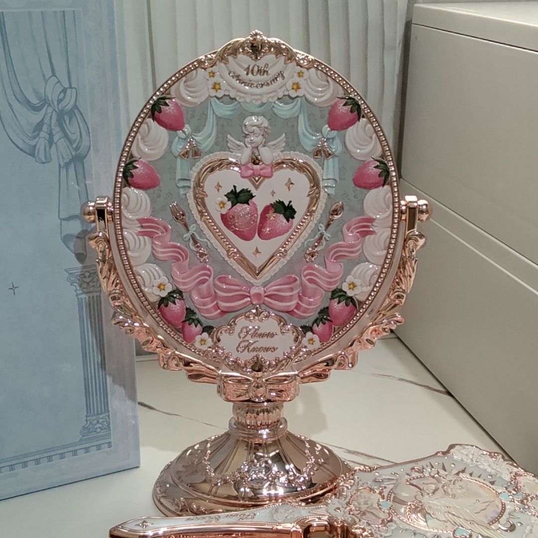 Flower Knows 10th Anniversary Desktop Vanity Mirror (Category: Mirrors) located in Manila. Submitted by rosarionav48057 (Listing ID 1469645742, Image 1). Description: - Authentic Flower Knows 10th Anniversary Collection desktop vanity mirror - Elegant rose gold finish with detailed strawberry and cupid motifs on the back - Double-sided pivoting design featuring a clear mirror on the reverse - Sturdy pedestal base with intricate decorative carving