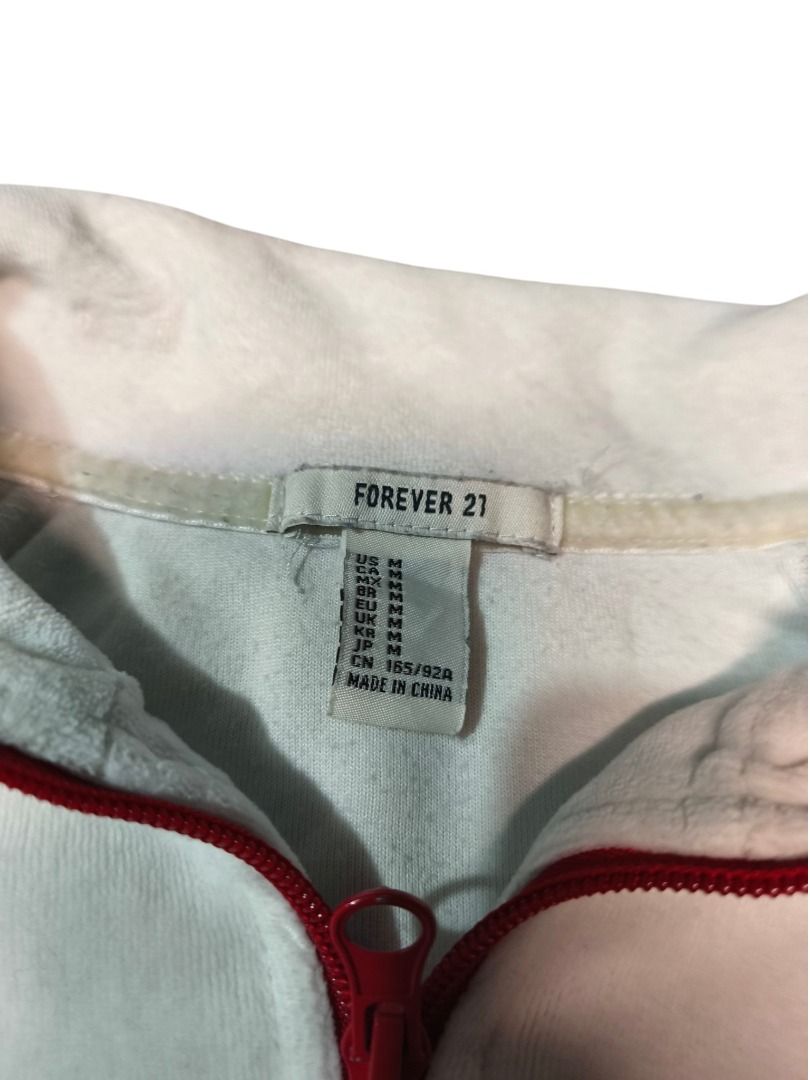 FOREVER 21 TRACK JACKET (Category: Coats, Jackets and Outerwear) located in Baguio. Submitted by boneteezandharmony (Listing ID 1469664902, Image 3). Description: White zip-up jacket with bold red zipper and striped ribbed hems. Simple sporty piece with a retro-inspired look..