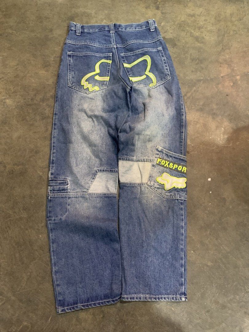 Fox Sportswear Denim Jeans (Category: Jeans) located in Cagayan de Oro. Submitted by agboysalis60090 (Listing ID 1469743040, Image 2). Description: Fox Sportswear denim jeans in medium blue wash. Features contrast stitching, neon green accents, and cargo pocket details on the legs. Branded buttons and embroidered fox logos on back pockets. Loose fit straight leg style. Tagged brand label inside waistband..
