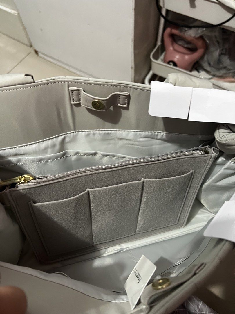 Francfranc Tool Bag Tote with Inner Pouch (Category: Luxury Bags & Wallets) located in Manila. Submitted by cleverstone_21f597 (Listing ID 1469670819, Image 2). Description: - Brand: Francfranc - Color: Greyish beige (Tag still attached) - Design: Quilted exterior with soft padded handles - Organization: Includes a removable inner zipper pouch with multiple slip pockets - Best for: Daily work gear, stationery, or a small laptop.