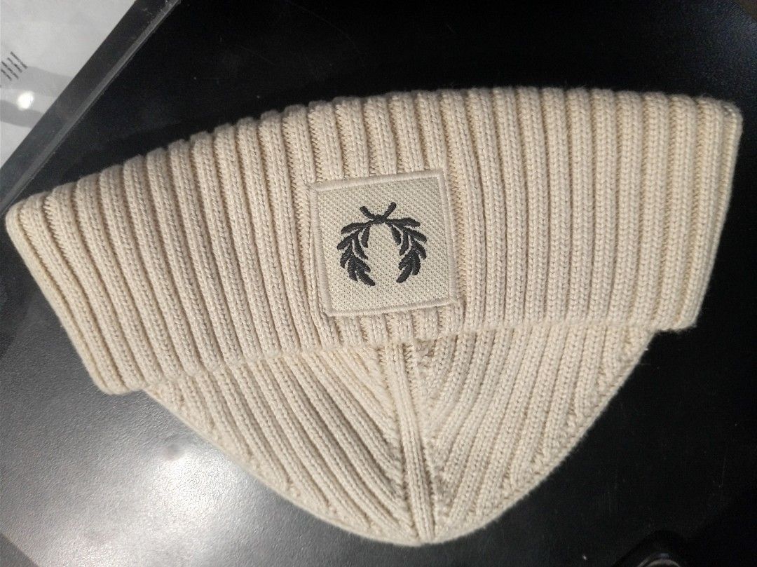 Fred Perry Ribbed Beanie Hat Cream (Category: Beanies) located in Makati City. Submitted by saicohtikz (Listing ID 1469699241, Image 2). Description: - Brand: Fred Perry - Color: Cream - Design: Ribbed knit with front foldover cuff - Logo: Iconic embroidered laurel wreath patch - Details: Inner tag with product code C6151 and London address - Origin: Made in China - Condition: Perfect cozy winter headwear accessory.