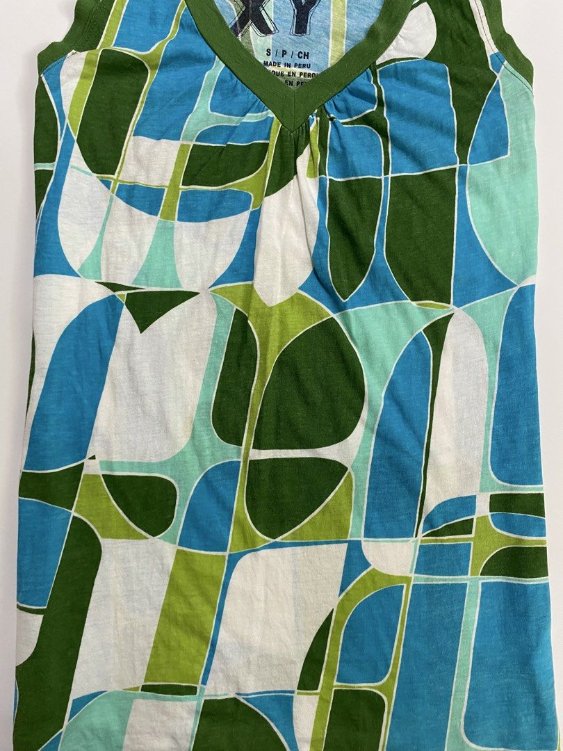 Frutiger aero roxy top (Category: Sleeveless) located in Dumangas. Submitted by hakdoooog (Listing ID 1469682223, Image 3). Description: - Brand: Roxy - Size: Small (Made in Peru) - Design: Blue, green, and white geometric pattern with olive green trim - Details: V-neck with gathered front detail - Fabric: Lightweight and breathable knit - Condition: Excellent, perfect for sunny days and easy styling.