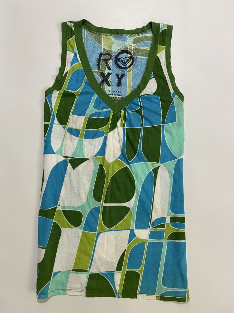 Frutiger aero roxy top (Category: Sleeveless) located in Dumangas. Submitted by hakdoooog (Listing ID 1469682223, Image 1). Description: - Brand: Roxy - Size: Small (Made in Peru) - Design: Blue, green, and white geometric pattern with olive green trim - Details: V-neck with gathered front detail - Fabric: Lightweight and breathable knit - Condition: Excellent, perfect for sunny days and easy styling.