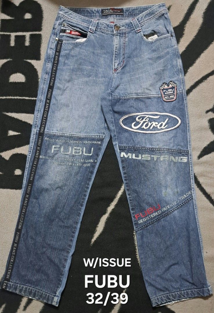 FUBU Jeans Ford Mustang Patchwork Denim Pants 32/39 (Category: Jeans) located in San Fernando, Camarines Sur. Submitted by ladderaya (Listing ID 1469642441, Image 1). Description: - Brand: FUBU - Style: Light blue wash denim pants with classic Y2K streetwear vibe - Details: Heavy patchwork, Ford and Mustang branding, NASCAR patch on the back pocket, and logo prints down the legs - Size: Tag reads 32/39 - Condition: Back leather patch is cracked a