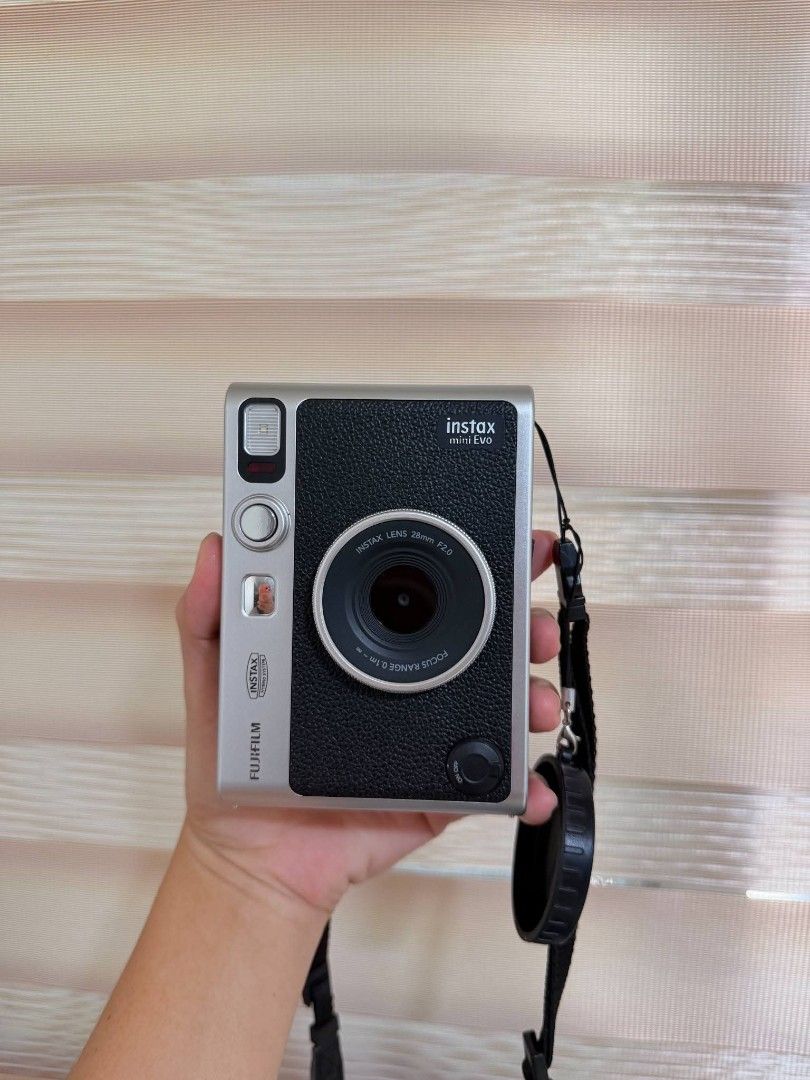 Fujifilm Instax Mini Evo Hybrid Instant Camera (Category: Cameras) located in Manila. Submitted by angell_dsartes (Listing ID 1469610747, Image 1). Description: - Model: Fujifilm Instax Mini Evo Hybrid Instant Camera (Black & Silver) - Condition: Great shape, zero flaws, original box included - Bundle includes: Clear case, black strap, lens cap with green heart, lens cap with pink heart, and dust plug - Perfect, ready-to-go set for your next hang