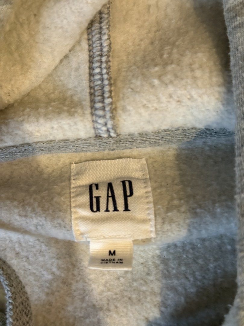 GAP Grey Hoodie Size M (Category: Hoodies) located in Muntinlupa City. Submitted by golf823 (Listing ID 1469681443, Image 2). Description: - Size: Medium - Color: Classic Grey - Design: Embroidered GAP logo on chest - Features: Drawstring hood & front kangaroo pocket - Interior: Soft fleece lining - Condition: Clean and ready to wear.
