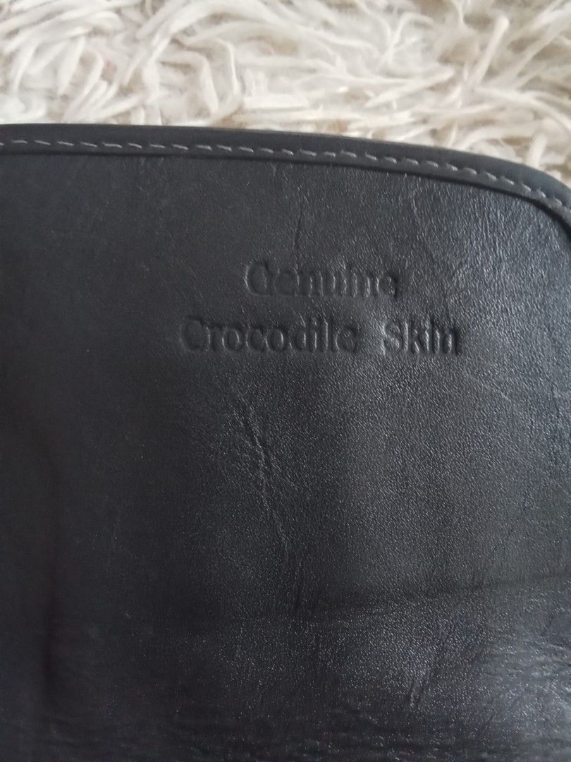 Genuine Crocodile Skin Black Long Wallet (Category: Wallets & Card holders) located in Caloocan City. Submitted by noy5o1a (Listing ID 1469638038, Image 3). Description: - Genuine black crocodile skin long wallet - Secure flap closure with magnetic snap - Multiple card slots, ID window, and bill compartments - Convenient zippered coin pocket - Stylish brown inner lining with crocodile skin pattern - Clean condition inside and out - Plenty of spac