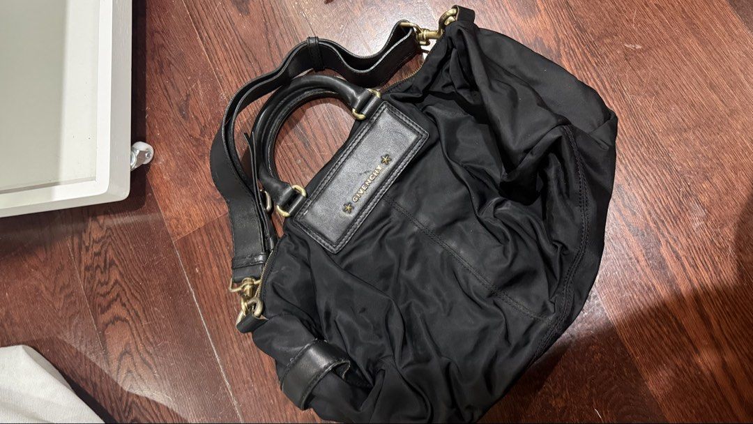 Givenchy Black Pandora (Price Negotiable) (Category: Luxury Bags & Wallets) located in Quezon City. Submitted by ryanbuysandsells (Listing ID 1469634542, Image 1). Description: - Brand: Givenchy - Color: Classic Black - Material: Soft, slouchy durable nylon - Hardware: Elegant gold-tone - Straps: Double top handles & adjustable/removable shoulder strap - Closure: Top zipper closure - Details: Front branded leather patch with signature star studs 