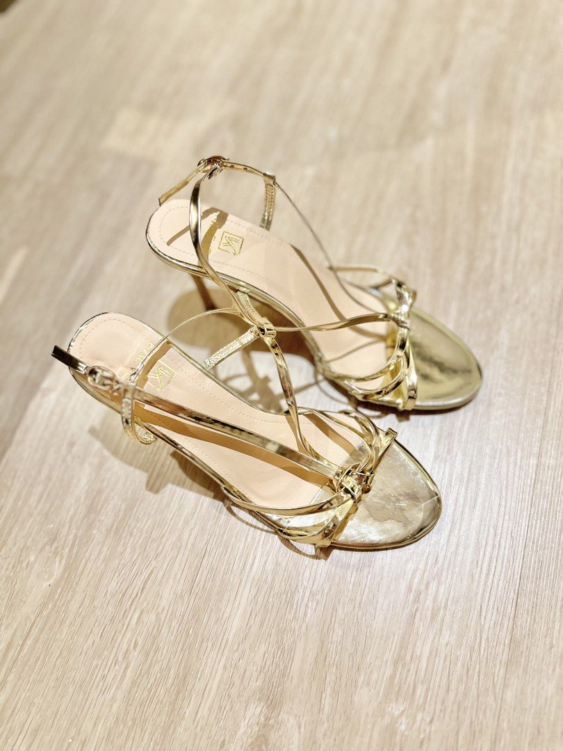 Gold Strappy High Heel Sandals (Category: Heels) located in Las Pinas. Submitted by ktmlmr (Listing ID 1469634473, Image 3). Description: 💛 NO ISSUE (still in great quality) ✨ 💛 Color & Finish: Gold metallic with a glossy patent finish 💛 Heel Style: Slim stiletto 💛 Design: Multi-strap front with delicate adjustable ankle strap 💛 Condition: Worn once for quick photoshoot (never used for walking outside) soles are still clean with minimal wear