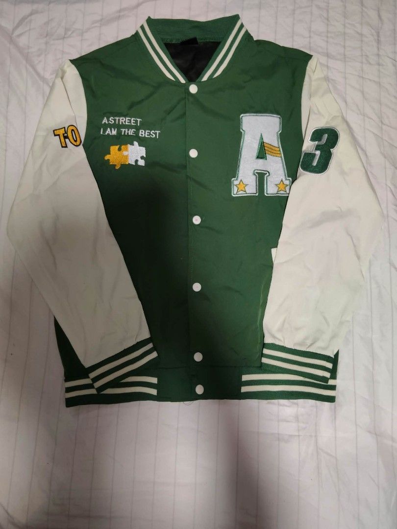 Green and White Varsity Jacket with Patches (Category: Coats, Jackets and Outerwear) located in Iligan City. Submitted by rebleza.archives (Listing ID 1469708957, Image 1). Description: - Color: Green body with contrasting white sleeves - Closure: Classic snap buttons - Accents: Large letter 'A' and number '3' patches on the front - Embroidery: 'ASTREET I AM THE BEST' text and puzzle piece graphic on the chest - Details: Striped ribbed collar, cu