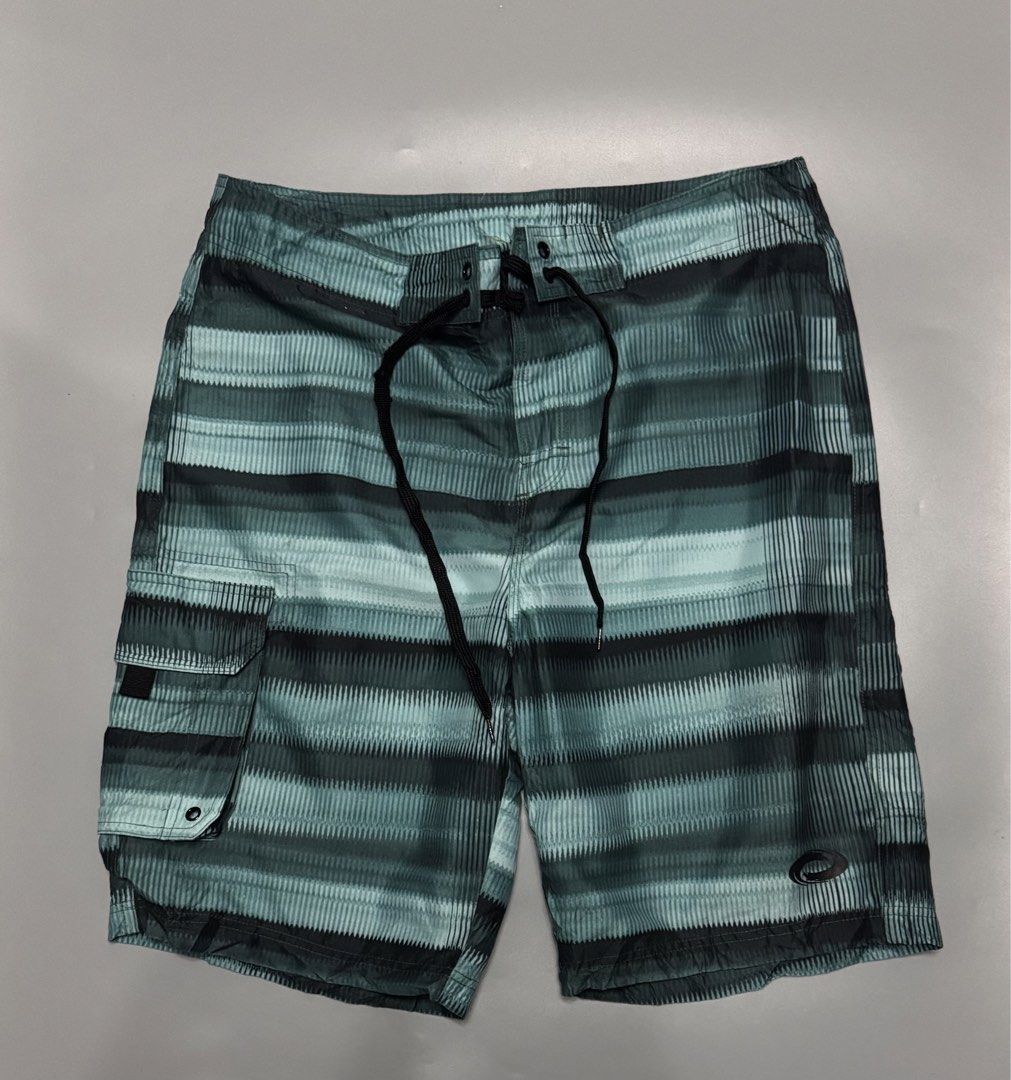 Green Striped Board Shorts Size 34 (Category: Swim Trunks & Board Shorts) located in Alaminos. Submitted by outfitcheck.ph (Listing ID 1469699076, Image 1). Description: - Size: 34 - Color: Green and black stripes - Material: 100% quick-dry polyester - Waistband: Adjustable drawstring with black cords - Pockets: Convenient side cargo pocket and small back pocket with velcro closure - Versatile: Great for swimming, the beach, or casual everyday we