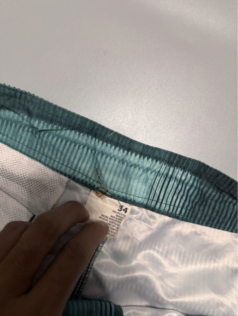 Green Striped Board Shorts Size 34 (Category: Swim Trunks & Board Shorts) located in Alaminos. Submitted by outfitcheck.ph (Listing ID 1469699076, Image 3). Description: - Size: 34 - Color: Green and black stripes - Material: 100% quick-dry polyester - Waistband: Adjustable drawstring with black cords - Pockets: Convenient side cargo pocket and small back pocket with velcro closure - Versatile: Great for swimming, the beach, or casual everyday we