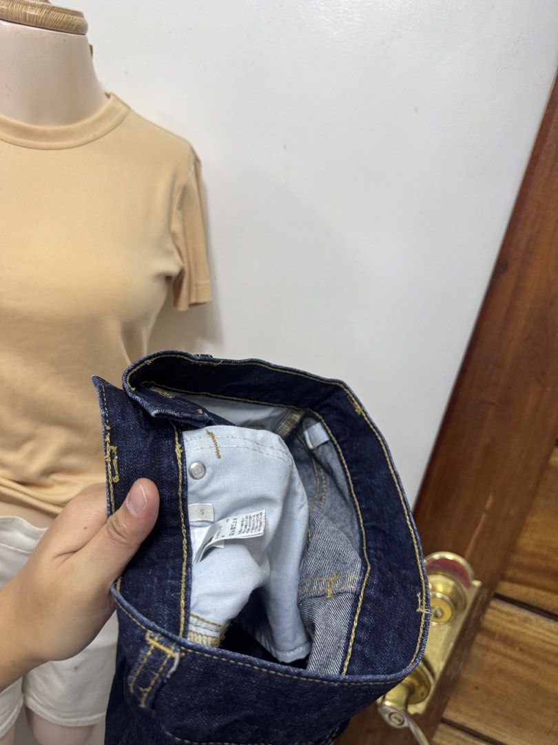 GU Ankle Jeans (Category: Jeans) located in Cavite. Submitted by yakultjeni85475 (Listing ID 1469728394, Image 3). Description: - Brand: GU - Size: Small - Color: Dark wash indigo with subtle seam fading - Fit: High-waisted with a straight leg cut - Details: Contrast yellow stitching, metal button closure - Style: Classic everyday staple, easy to pair with any top or shoes.