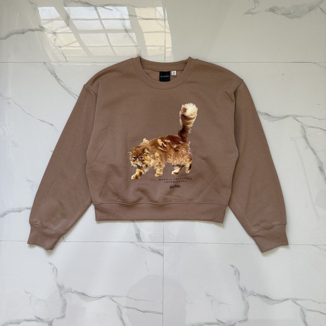 GU Harry Potter Crookshanks Sweatshirt Pullover (Category: Coats, Jackets and Outerwear) located in Santo Tomas. Submitted by the580closet (Listing ID 1469689036, Image 1). Description: - Size: XL 21.5 inches - chest 21 inches - length .