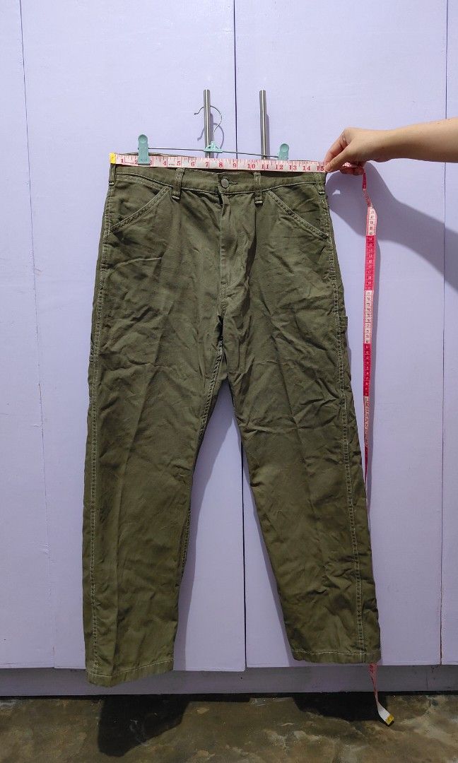 GU olive green utility cargo pants (Category: Trousers) located in Bacolor. Submitted by annjjjjj (Listing ID 1469643310, Image 2). Description: - Color: Olive green - Style: Relaxed fit with straight leg cut - Details: Multiple utility pockets and stylish contrast stitching - Waist: Mid-rise with belt loops - Material: Sturdy, durable fabric ideal for everyday casual wear.