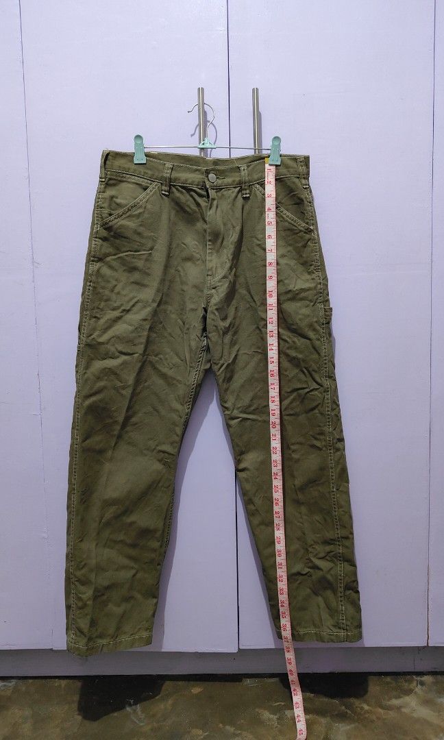 GU olive green utility cargo pants (Category: Trousers) located in Bacolor. Submitted by annjjjjj (Listing ID 1469643310, Image 3). Description: - Color: Olive green - Style: Relaxed fit with straight leg cut - Details: Multiple utility pockets and stylish contrast stitching - Waist: Mid-rise with belt loops - Material: Sturdy, durable fabric ideal for everyday casual wear.