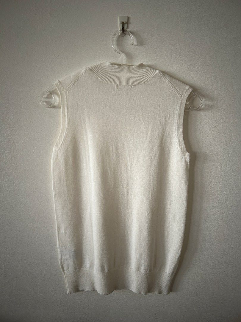 GU White Knit Mock Neck Tank Top (Category: Sleeveless) located in Makati City. Submitted by kt1030 (Listing ID 1469575824, Image 2). Description: - Brand: GU - Color: Crisp White - Style: Sleeveless knit top with mock neck - Material: Soft and lightweight rayon-nylon blend - Details: Ribbed texture at neckline and hem - Versatility: Great basic piece for layering or standalone wear.