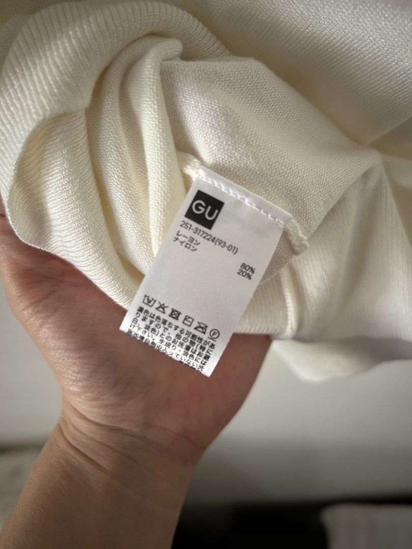 GU White Knit Mock Neck Tank Top (Category: Sleeveless) located in Makati City. Submitted by kt1030 (Listing ID 1469575824, Image 3). Description: - Brand: GU - Color: Crisp White - Style: Sleeveless knit top with mock neck - Material: Soft and lightweight rayon-nylon blend - Details: Ribbed texture at neckline and hem - Versatility: Great basic piece for layering or standalone wear.