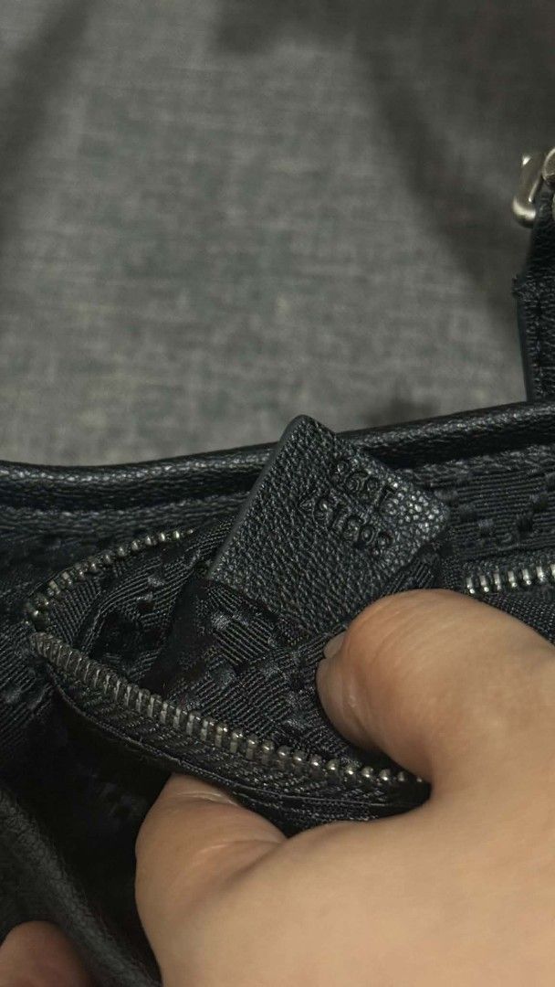 Gucci Black GG Monogram Canvas Shoulder Bag (Category: Luxury Bags & Wallets) located in Cavite. Submitted by loriojenni09117 (Listing ID 1469699710, Image 2). Description: - 21212Gucci black shoulder bag - Classic GG monogram canvas with dark hardware - Secure piston lock front closure - Clean interior with zip pocket, leather tag, and serial numbers - Includes an extra strap - Well-kept, clean inside and out.