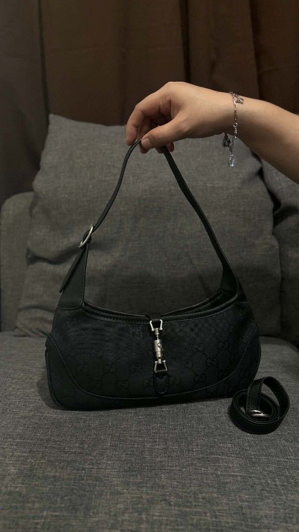Gucci Black GG Monogram Canvas Shoulder Bag (Category: Luxury Bags & Wallets) located in Cavite. Submitted by loriojenni09117 (Listing ID 1469699710, Image 1). Description: - 21212Gucci black shoulder bag - Classic GG monogram canvas with dark hardware - Secure piston lock front closure - Clean interior with zip pocket, leather tag, and serial numbers - Includes an extra strap - Well-kept, clean inside and out.