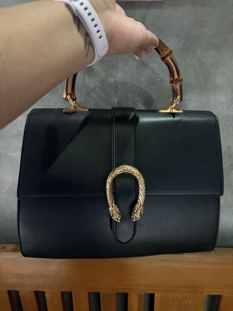 Gucci Black Leather Bamboo Top Handle Bag (Category: Luxury Bags & Wallets) located in Manila. Submitted by micahjobag35066 (Listing ID 1469642495, Image 2). Description: - Authentic Gucci Black Leather Handbag - Distinctive bamboo top handle and gold-tone hardware - Iconic horseshoe tiger head closure - Light-coloured fabric lining with an internal zip compartment - Comes with 2 interchangeable straps: classic leather and the signature green-red