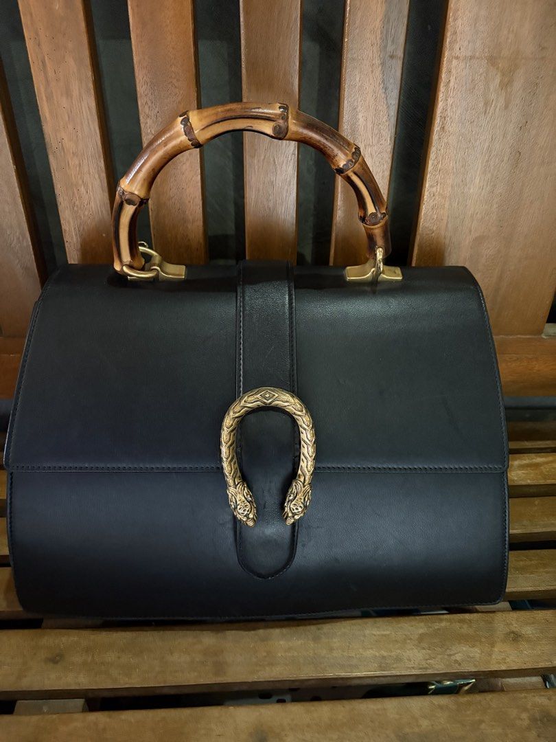 Gucci Black Leather Bamboo Top Handle Bag (Category: Luxury Bags & Wallets) located in Manila. Submitted by micahjobag35066 (Listing ID 1469642495, Image 1). Description: - Authentic Gucci Black Leather Handbag - Distinctive bamboo top handle and gold-tone hardware - Iconic horseshoe tiger head closure - Light-coloured fabric lining with an internal zip compartment - Comes with 2 interchangeable straps: classic leather and the signature green-red