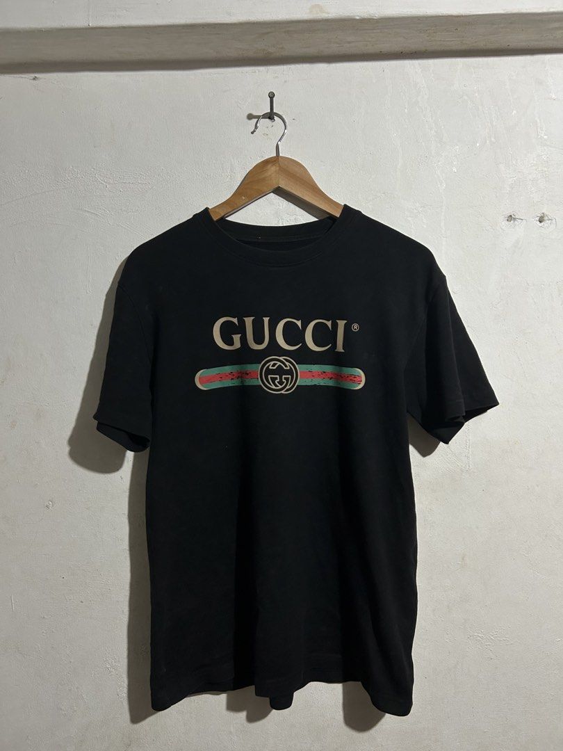 Gucci Black Logo T-shirt (Category: Tshirts & Polo Shirts ) located in Manila. Submitted by romnick907 (Listing ID 1469705467, Image 1). Description: - Brand: Gucci - Color: Classic Black with beige, red, and green vintage distressed logo - Size: Small - Material: 100% Cotton, Made in Italy - Care: Hand wash only - Fit: Straightforward casual fit, perfect for streetwear - Condition: Excellent / Well-maintained.