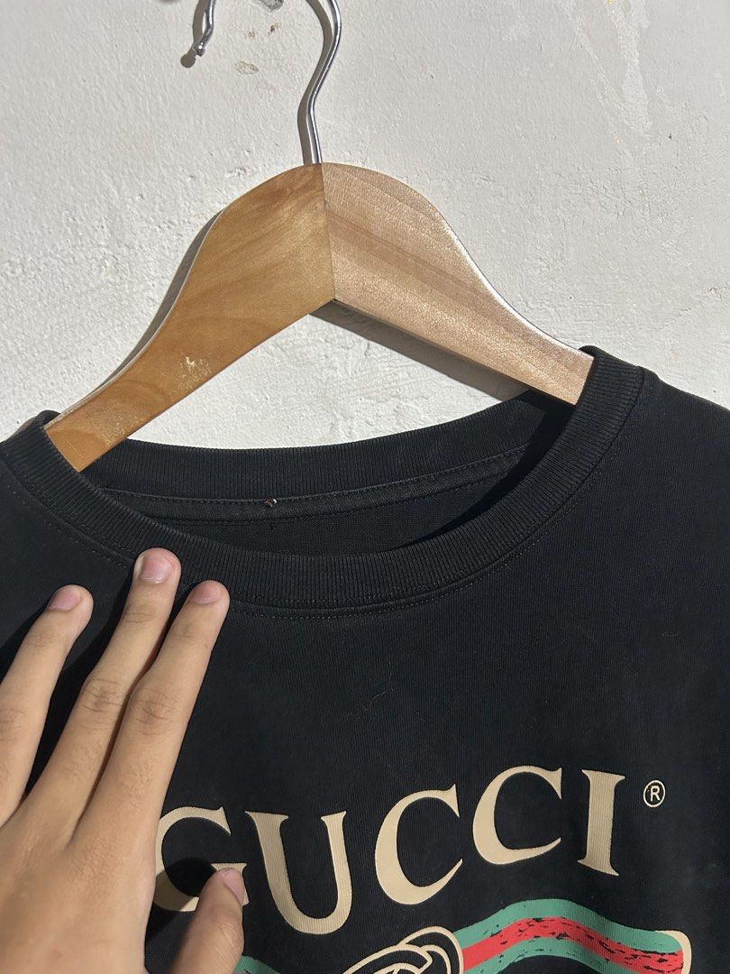 Gucci Black Logo T-shirt (Category: Tshirts & Polo Shirts ) located in Manila. Submitted by romnick907 (Listing ID 1469705467, Image 2). Description: - Brand: Gucci - Color: Classic Black with beige, red, and green vintage distressed logo - Size: Small - Material: 100% Cotton, Made in Italy - Care: Hand wash only - Fit: Straightforward casual fit, perfect for streetwear - Condition: Excellent / Well-maintained.