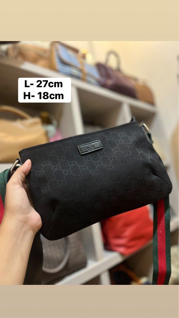 Gucci Black Monogram Crossbody Bag Web Stripe Strap (Category: Luxury Bags & Wallets) located in Bacolod City. Submitted by vintage_vogue6100 (Listing ID 1469671094, Image 1). Description: - Authentic Gucci crossbody bag in classic black nylon with GG monogram pattern - Features the iconic green and red web strap for that signature luxury look - Approximate dimensions: 27cm (L) x 18cm (H) - Secure top zip closure with leather pull and silver-tone