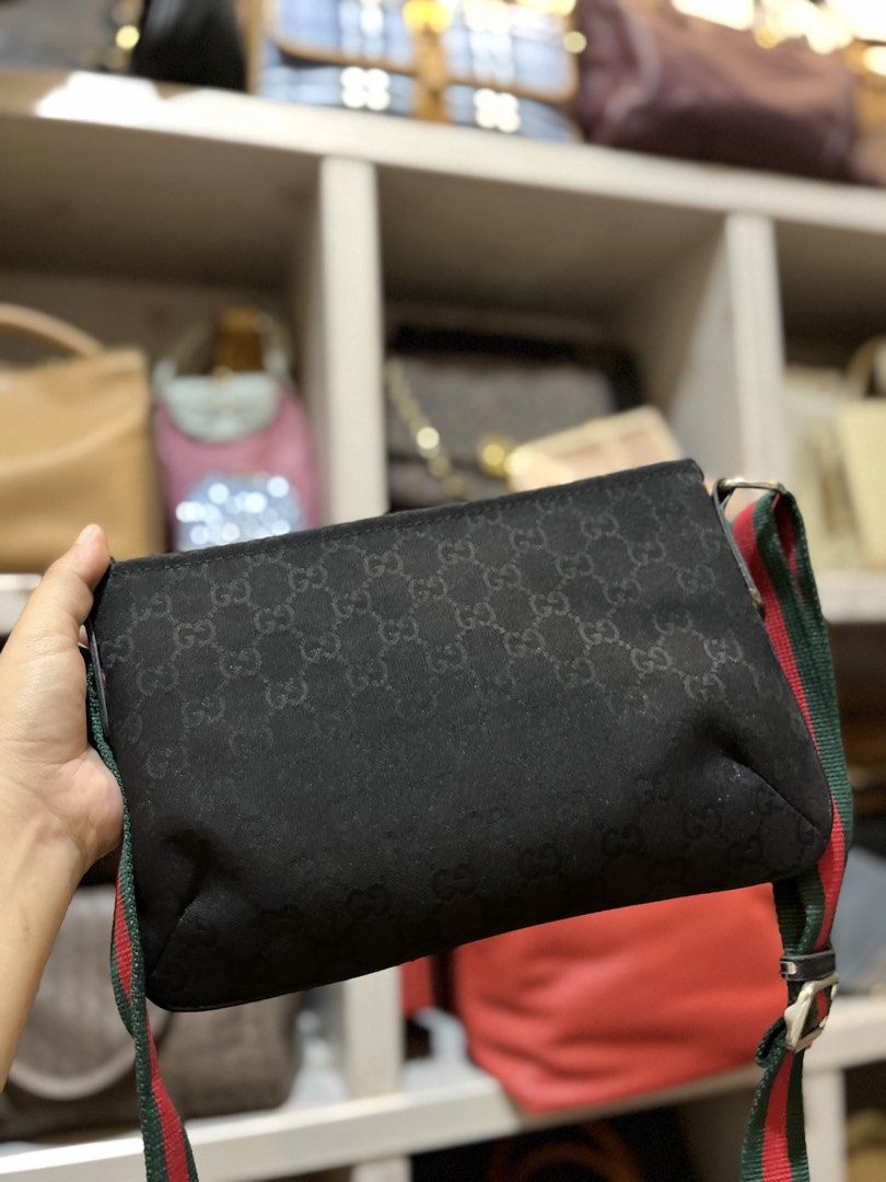 Gucci Black Monogram Crossbody Bag Web Stripe Strap (Category: Luxury Bags & Wallets) located in Bacolod City. Submitted by vintage_vogue6100 (Listing ID 1469671094, Image 3). Description: - Authentic Gucci crossbody bag in classic black nylon with GG monogram pattern - Features the iconic green and red web strap for that signature luxury look - Approximate dimensions: 27cm (L) x 18cm (H) - Secure top zip closure with leather pull and silver-tone