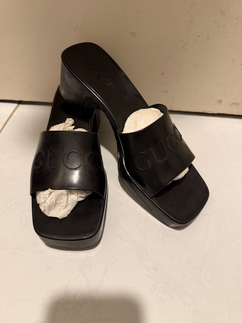 Gucci Black Platform Heels Sandals (Category: Sandals) located in Angono. Submitted by wisepenguin.ba57f4 (Listing ID 1469645190, Image 1). Description: - Brand: Gucci - Style: Chunky platform block heel mules / slip-on sandals - Color: Black - Details: Embossed Gucci logo on wide strap, trendy square toe design - Soles: Rubber soles with visible wear on the bottom tread - Condition: Pre-loved, well-kept upper with normal wear on soles.