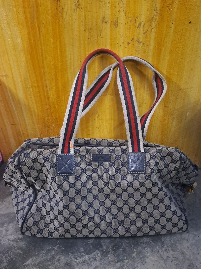 Gucci GG Canvas Web Travel / Duffle Bag (Category: Luxury Bags & Wallets) located in Puerto Princesa. Submitted by jercksthriftph (Listing ID 1469588984, Image 1). Description: Gucci GG Monogram Canvas Web Travel / Duffle Bag , Excellent Condition need cleaning item is thrifted/ukay.