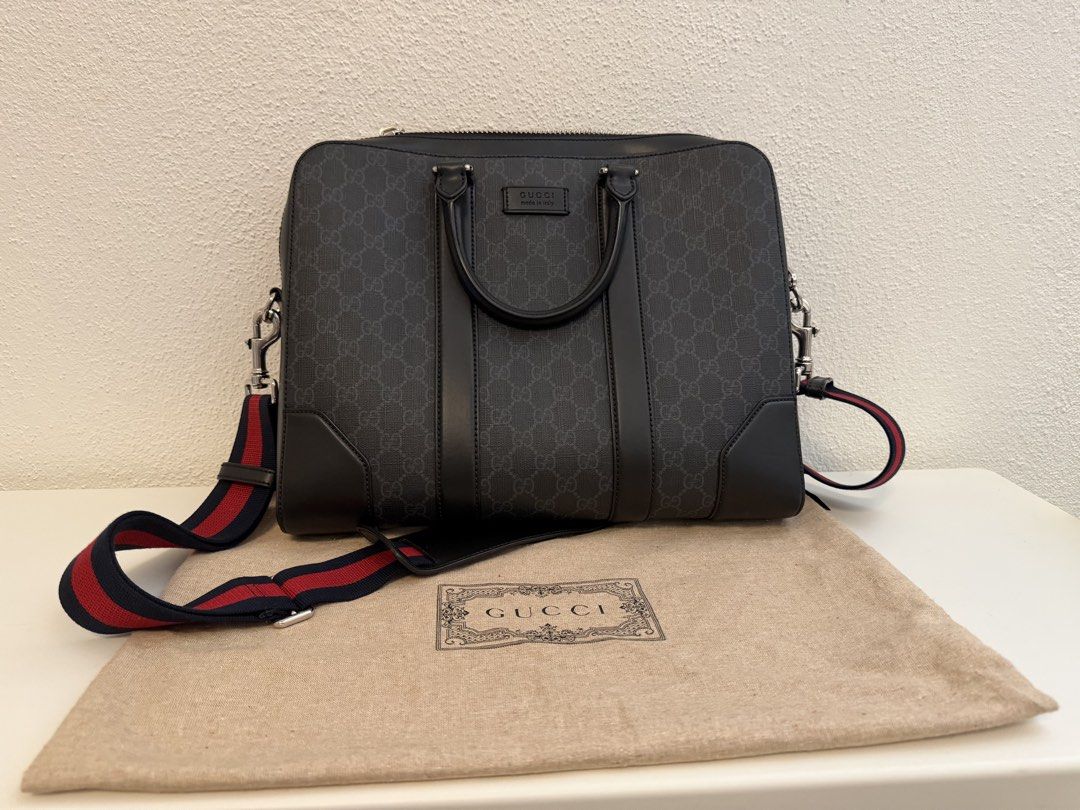 Gucci GG Supreme Black Leather Briefcase (Category: Luxury Bags & Wallets) located in Pasig City. Submitted by closetofashopaholic (Listing ID 1469680507, Image 3). Description: - Authentic Gucci GG Supreme canvas briefcase in black - Spacious interior designed for daily work essentials or travel - Sturdy top handles and a detachable blue/red Web stripe shoulder strap - Premium leather corner reinforcements and embossed Gucci logo tag - Includes 