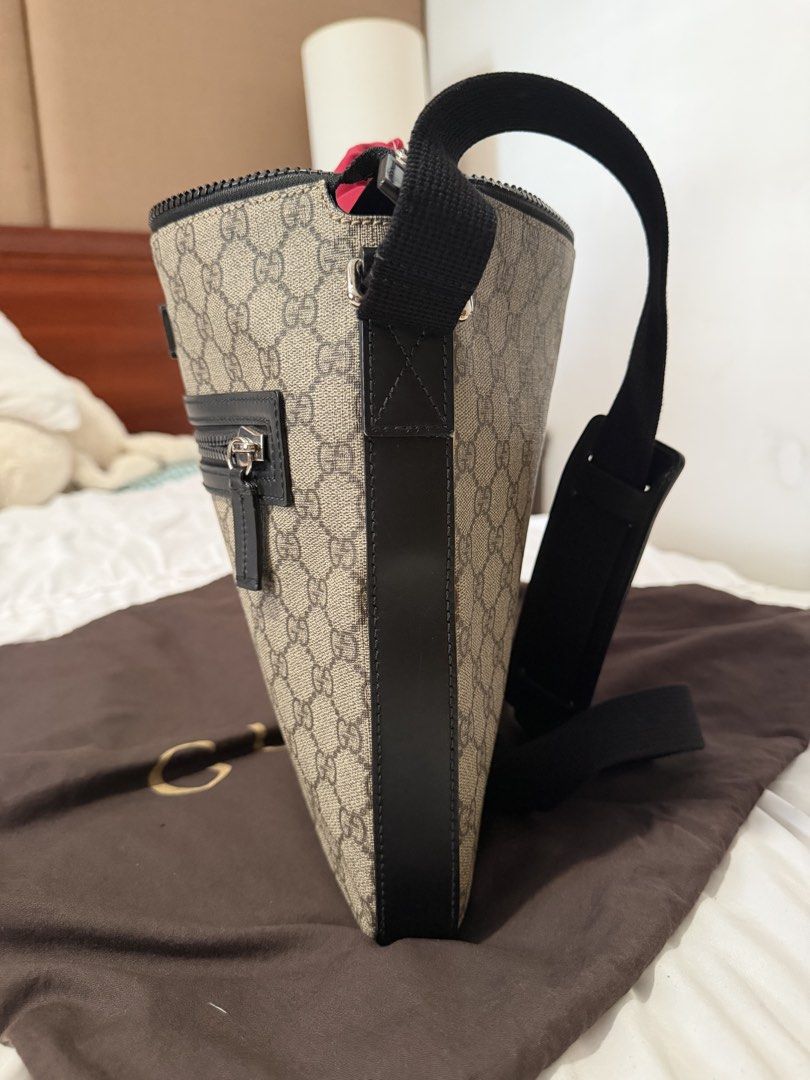 Gucci GG Supreme Messenger Flat Bag (Category: Sling Bags) located in Cavite. Submitted by gentlyused_ (Listing ID 1469682678, Image 3). Description: - Authentic Gucci messenger bag in classic GG Supreme canvas - Sleek black leather trim and adjustable strap for comfortable wear - Front zip pocket with polished silver-tone hardware - Secure top zip closure opening to a striking bright red interior lining - Ideal everyday crossbody size and shape 