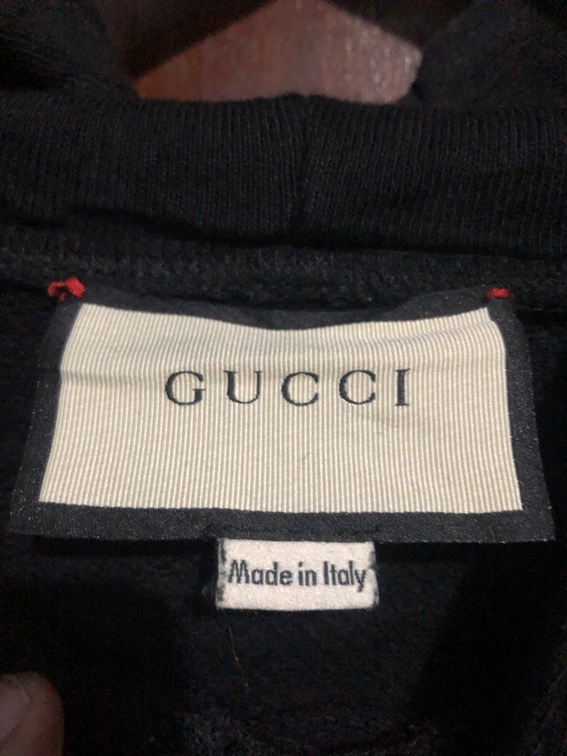 Gucci Interlocking G Star Patch Black Hoodie (Category: Coats, Jackets and Outerwear) located in Quezon City. Submitted by yeahsource222 (Listing ID 1469745172, Image 3). Description: - Brand: Gucci - Color: Black with red interlocking G logo and green star patches - Size: Medium (M) - Material: 100% Cotton - Origin: Made in Italy - Features: Drawstring hood, ribbed cuffs and hem, relaxed fit - Condition: Excellent, well-maintained - Mode of tran
